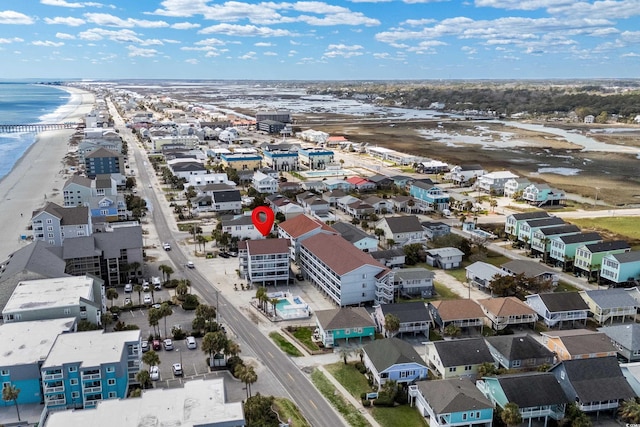 drone / aerial view with a water view and a view of the beach