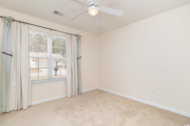 unfurnished room with visible vents, ceiling fan, light carpet, and baseboards