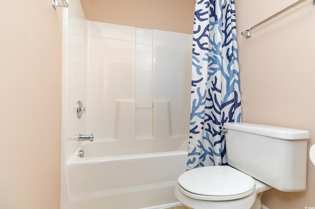 full bathroom featuring shower / bath combo with shower curtain and toilet