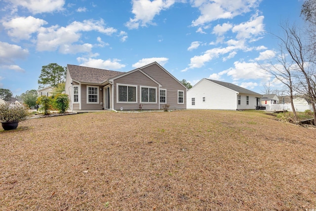 back of house featuring a lawn