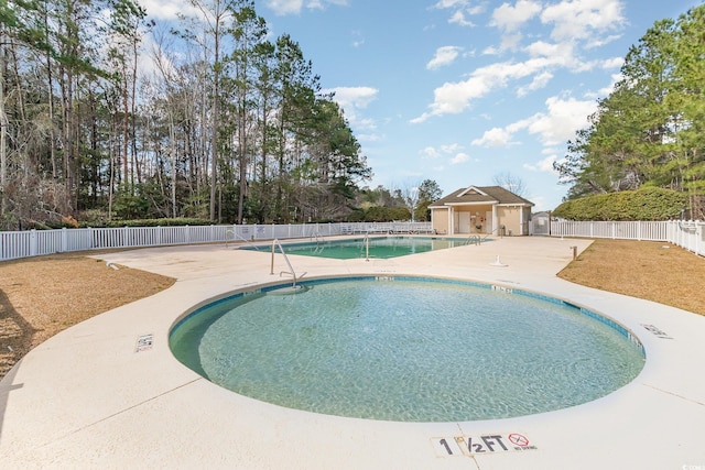 community pool featuring a patio area and fence