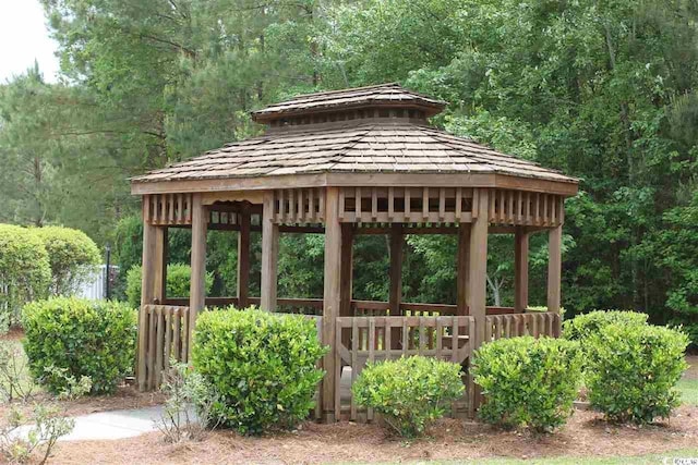 view of home's community with a view of trees and a gazebo