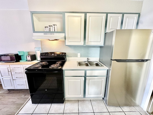 kitchen with black appliances, under cabinet range hood, light countertops, white cabinetry, and a sink