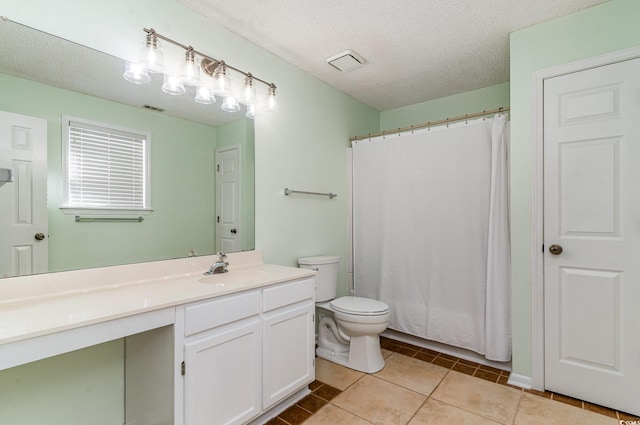 full bathroom with visible vents, toilet, a textured ceiling, vanity, and tile patterned floors