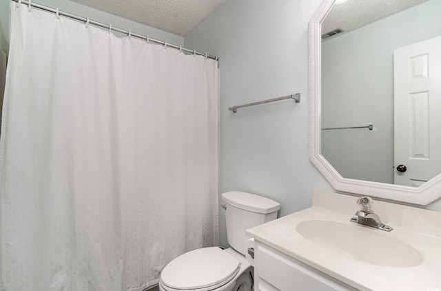 bathroom featuring visible vents, a textured ceiling, toilet, and vanity