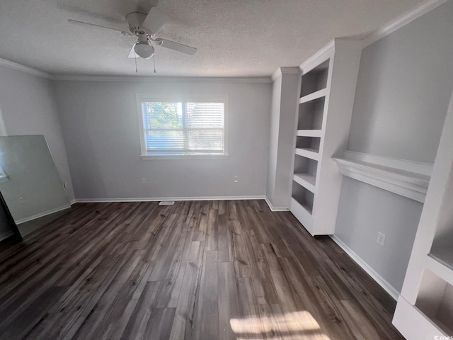 unfurnished living room featuring built in features, baseboards, ornamental molding, dark wood-style flooring, and a textured ceiling