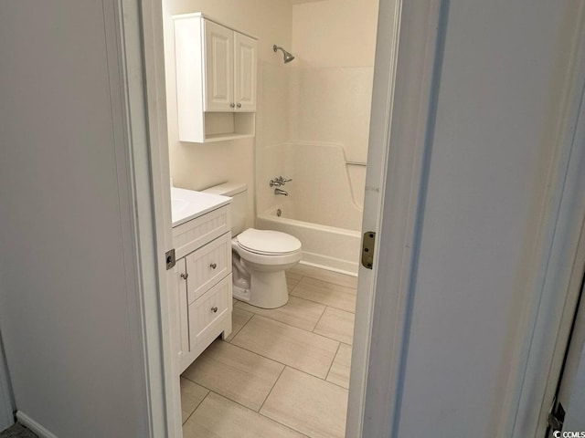 full bath featuring toilet, tile patterned flooring, bathtub / shower combination, and vanity