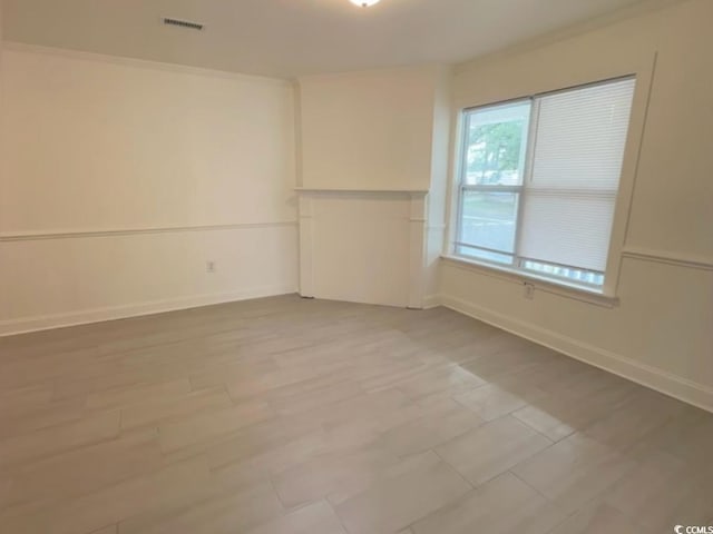 spare room featuring visible vents and baseboards