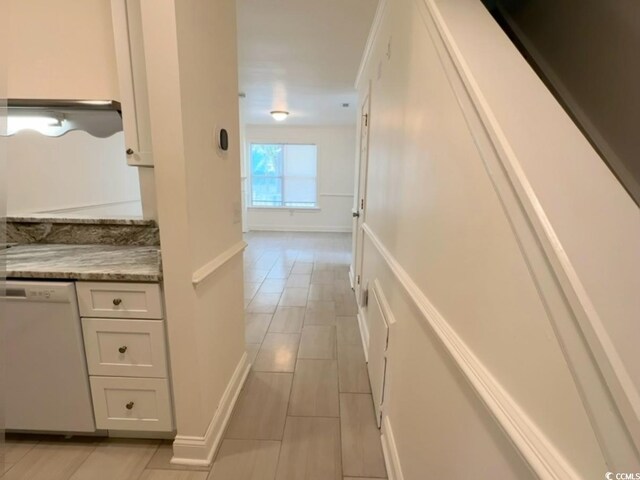 hallway featuring baseboards