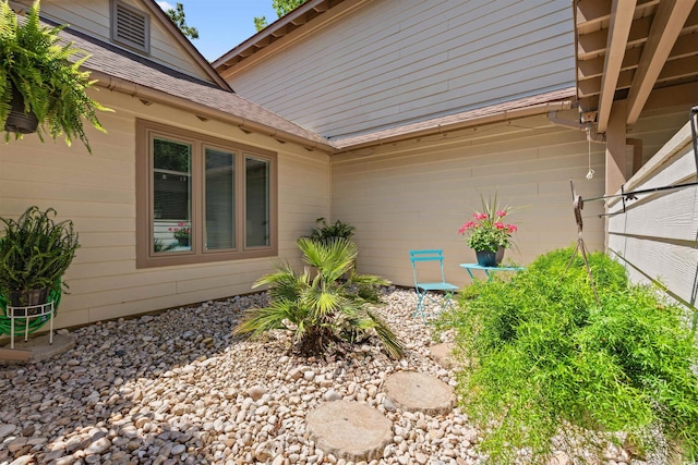 view of home's exterior with a shingled roof