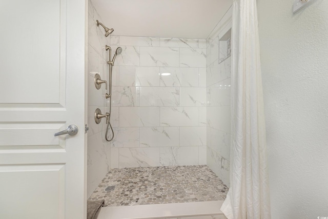 bathroom with tiled shower