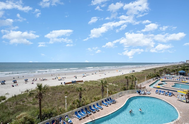 community pool with a beach view and a water view