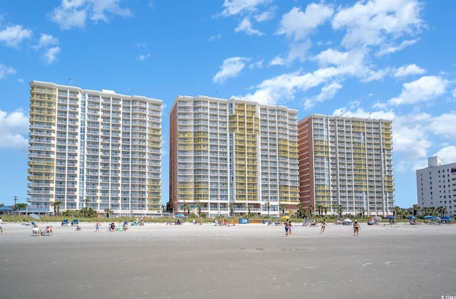 view of property featuring a beach view and a water view
