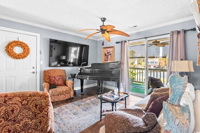 living area featuring visible vents, wood finished floors, a textured ceiling, and ornamental molding