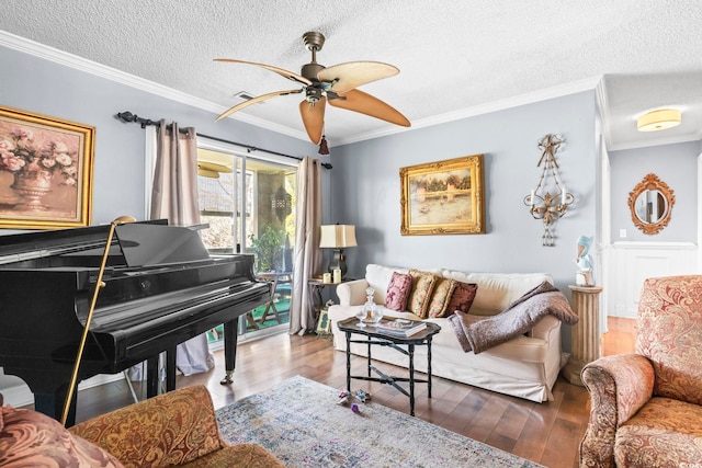 living room with a textured ceiling, crown molding, ceiling fan, and wood finished floors