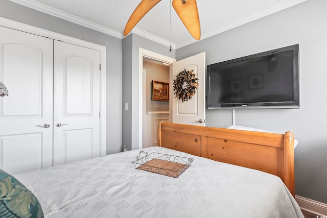 bedroom featuring a closet, a textured ceiling, and crown molding