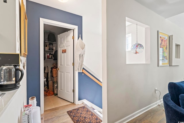 interior space featuring baseboards and wood finished floors