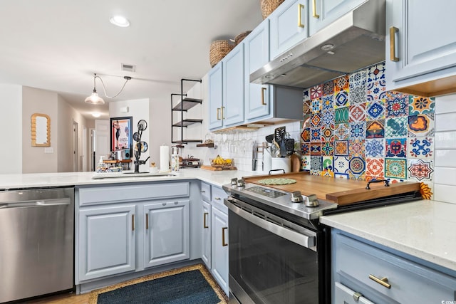 kitchen featuring under cabinet range hood, a sink, visible vents, appliances with stainless steel finishes, and backsplash