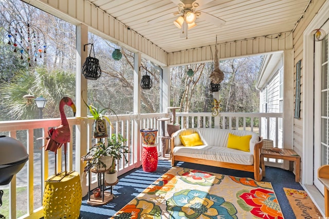 sunroom / solarium featuring ceiling fan