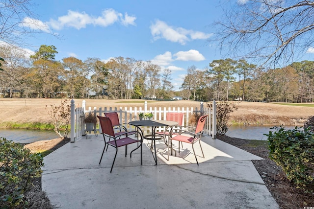 view of patio / terrace featuring outdoor dining space and a water view