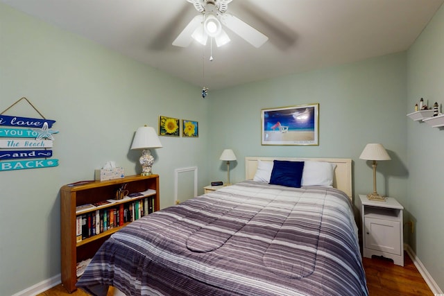 bedroom featuring ceiling fan, wood finished floors, and baseboards