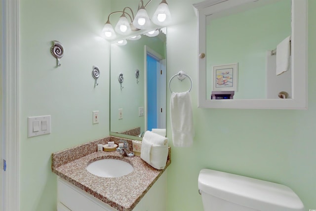 bathroom featuring toilet and vanity