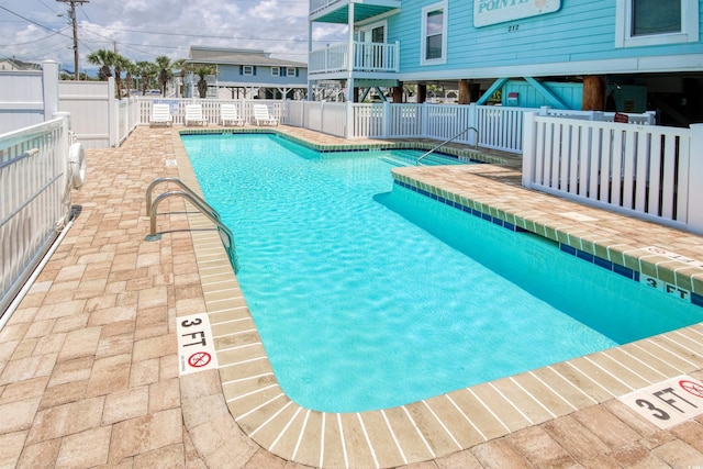 pool with fence and a patio