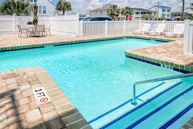 pool with fence and a patio