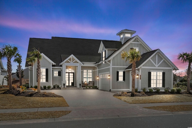 view of front facade featuring a garage, concrete driveway, and board and batten siding