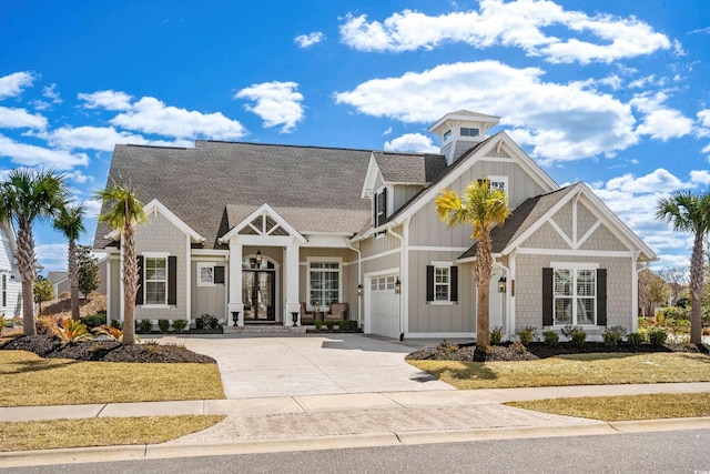 craftsman inspired home featuring board and batten siding, a garage, french doors, a shingled roof, and concrete driveway