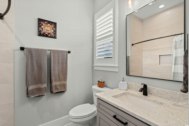 bathroom with toilet, vanity, and a shower with curtain