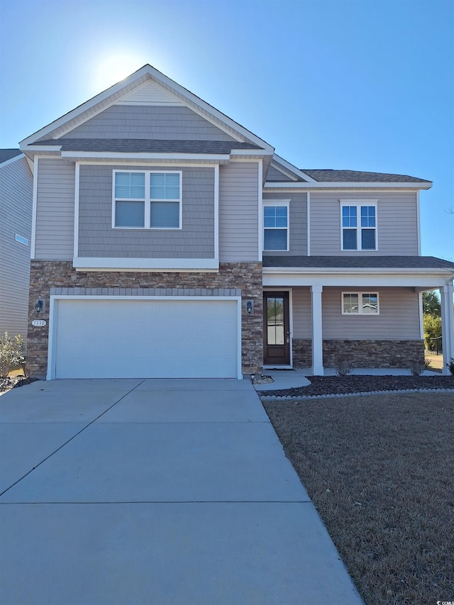 view of front facade featuring an attached garage, stone siding, and driveway