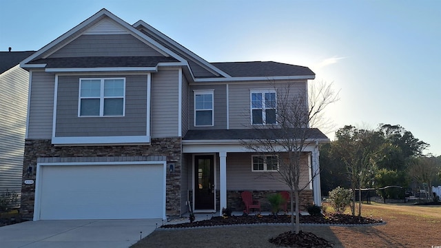 view of front facade featuring a garage, stone siding, concrete driveway, and a shingled roof