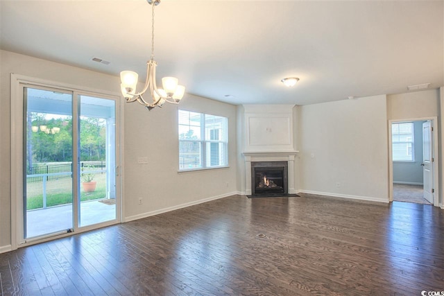 unfurnished living room featuring visible vents, a fireplace with flush hearth, baseboards, and dark wood-style floors