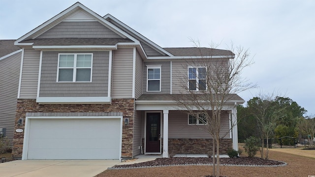 view of front of home with stone siding, an attached garage, driveway, and a shingled roof