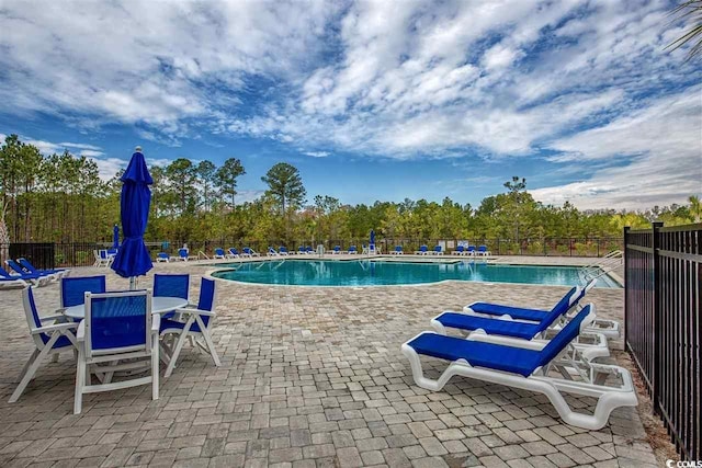 pool featuring a patio area and fence