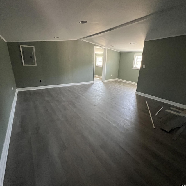 basement featuring wood finished floors, baseboards, and ornamental molding