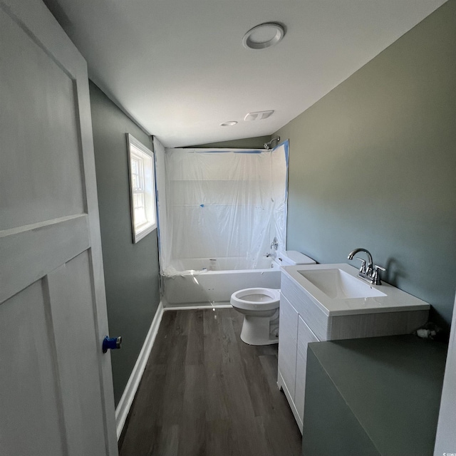 bathroom with wood finished floors, visible vents, baseboards,  shower combination, and toilet