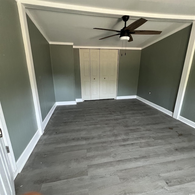 unfurnished bedroom with a closet, a ceiling fan, baseboards, and wood finished floors