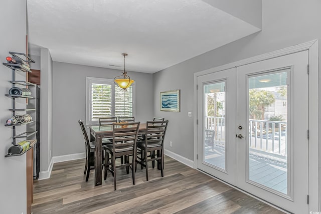 dining area with french doors, wood finished floors, and baseboards