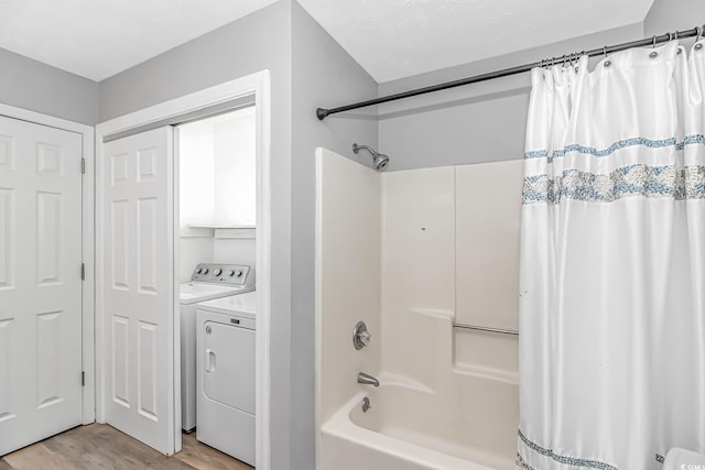 full bathroom with shower / bath combo, wood finished floors, and washer and dryer