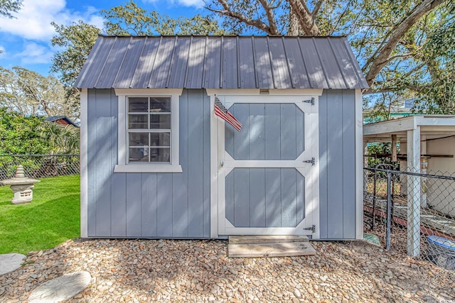 view of shed featuring fence