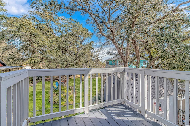 wooden terrace featuring a yard