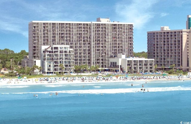 exterior space featuring a beach view and a water view