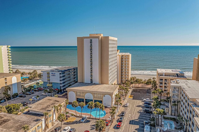 drone / aerial view with a water view and a view of the beach