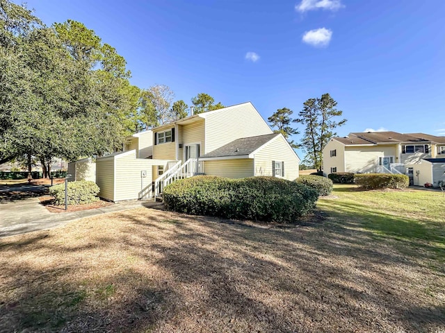 view of side of property with a lawn