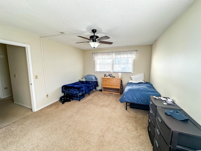 bedroom with light carpet, a textured ceiling, and ceiling fan