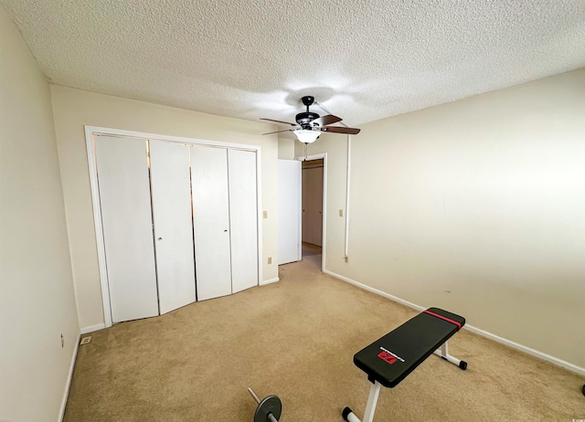 unfurnished bedroom with carpet flooring, a ceiling fan, and a textured ceiling