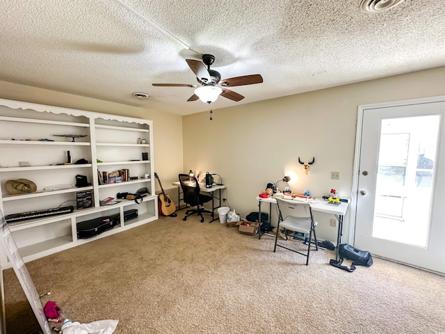 office space with ceiling fan, a textured ceiling, and carpet