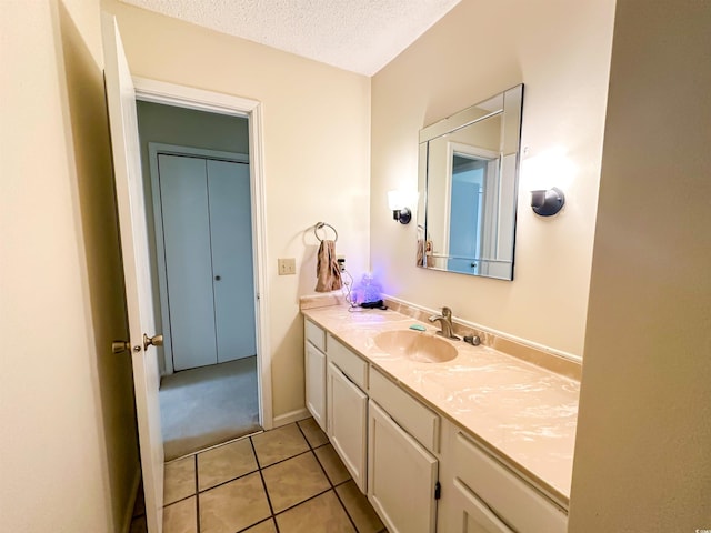 bathroom featuring tile patterned floors, a textured ceiling, and vanity